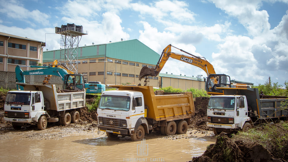 Excavators and tipper trucks on an industrial site