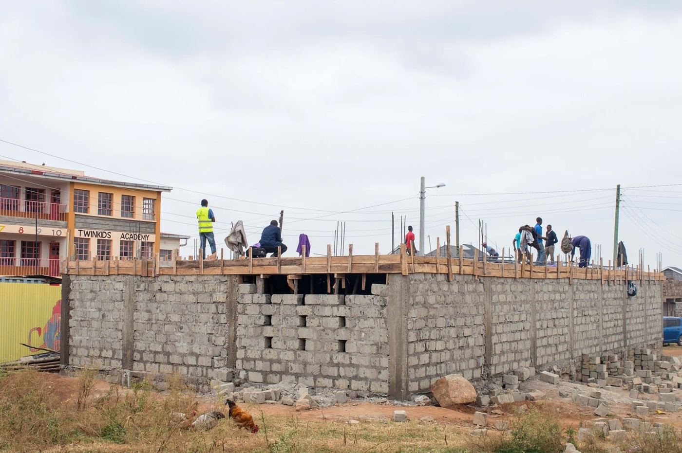 Masons raising block walls on site